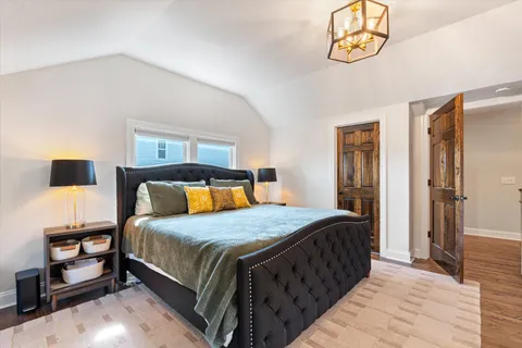 a living room with furniture a flat screen tv and a floor to ceiling window