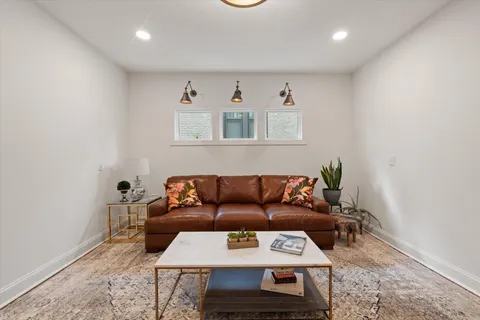 a front view of a house with a yard and potted plants