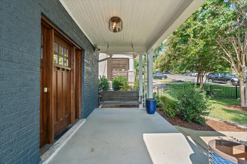 a view of a porch with plants and garden