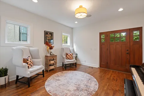 a living room with furniture and a potted plant