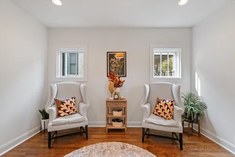 a living room with furniture and wooden floor