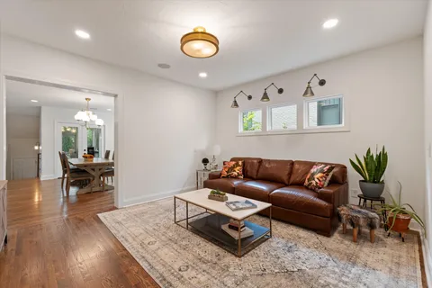 a living room with furniture and wooden floor