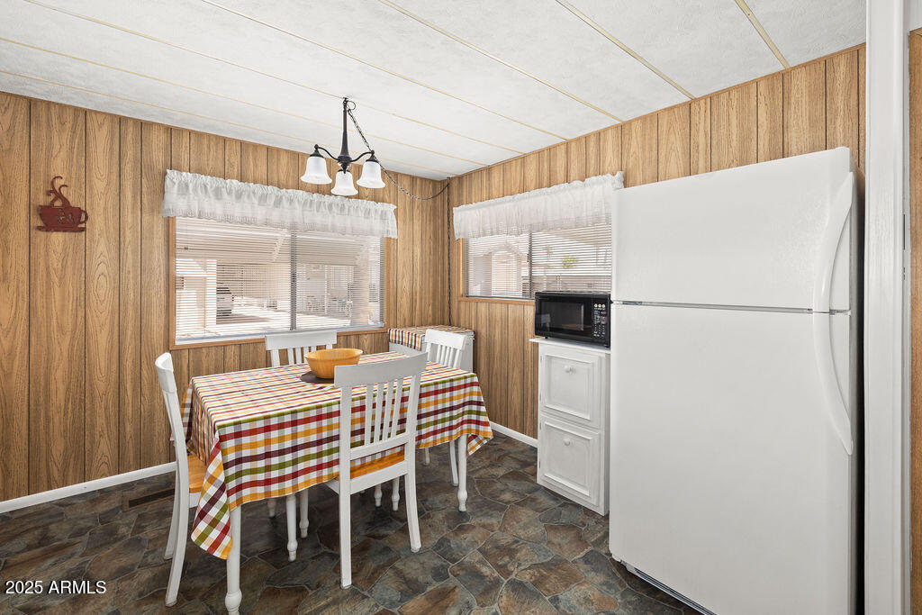 10220 East Apache Trail, Unit 16 Apache Junction, AZ 85120 - Photo 11 of 49 a dining room with furniture window and wooden floor