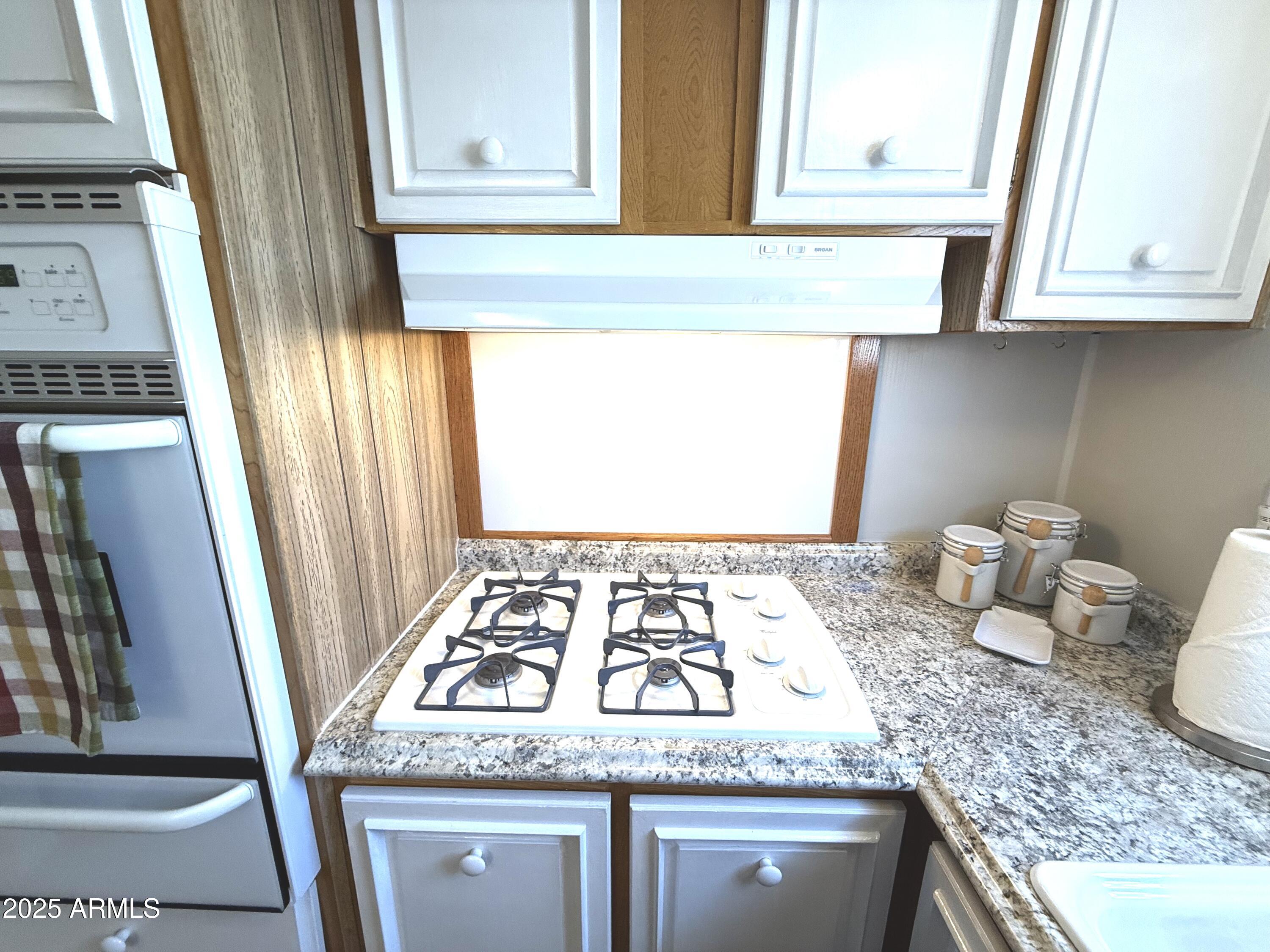10220 East Apache Trail, Unit 16 Apache Junction, AZ 85120 - Photo 13 of 49 a kitchen with granite countertop sink and cabinets