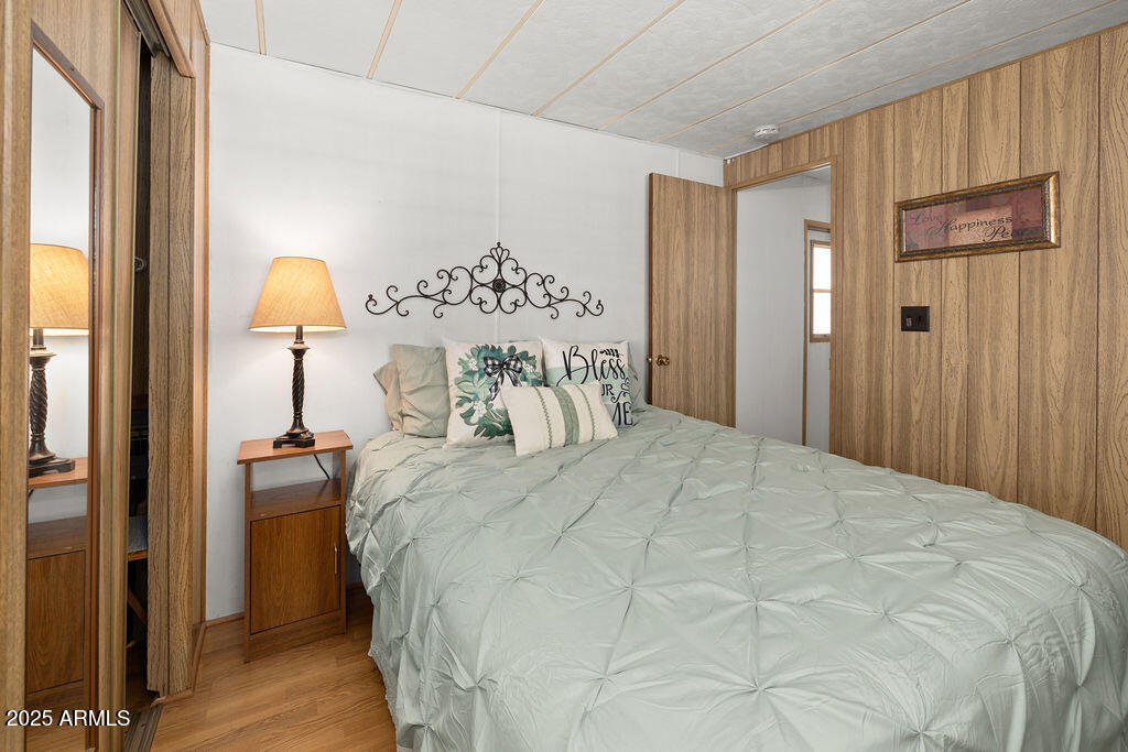 10220 East Apache Trail, Unit 16 Apache Junction, AZ 85120 - Photo 18 of 49 a bedroom with a bed and a chandelier