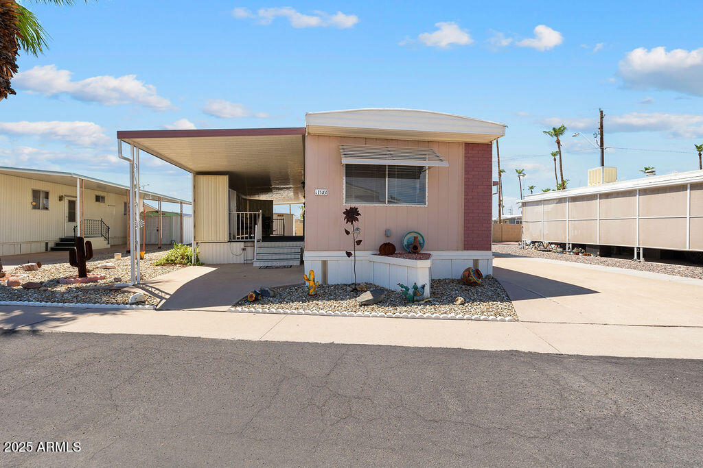10220 East Apache Trail, Unit 16 Apache Junction, AZ 85120 - Photo 2 of 49 a view of living room filled with furniture and kitchen view