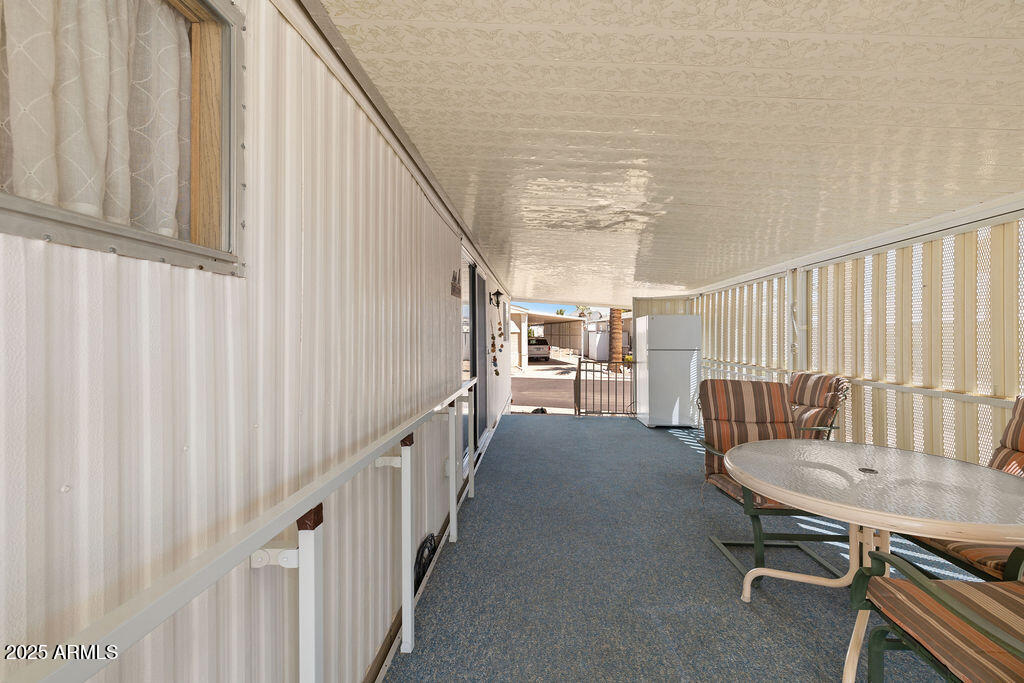 10220 East Apache Trail, Unit 16 Apache Junction, AZ 85120 - Photo 24 of 49 a view of a hallway with wooden floor and furniture