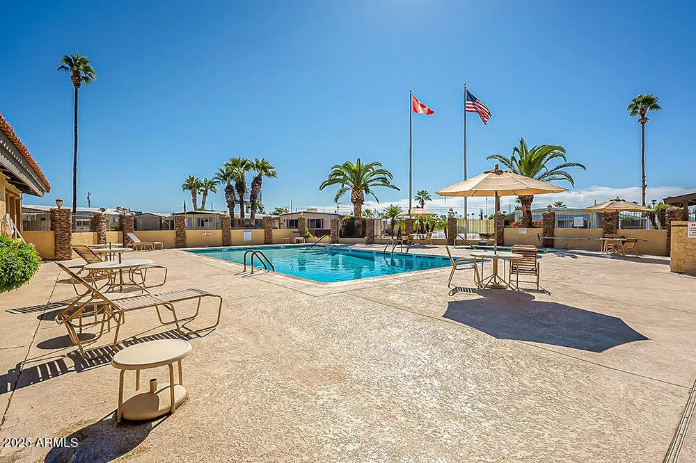 10220 East Apache Trail, Unit 16 Apache Junction, AZ 85120 - Photo 47 of 49 a view of a swimming pool with a patio