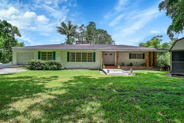 a front view of house with yard and green space