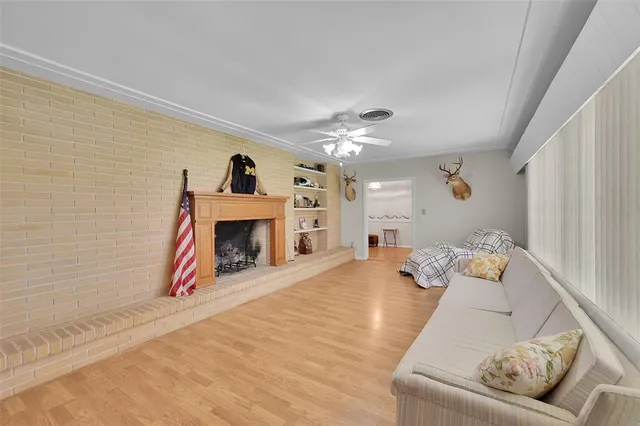 a kitchen with stainless steel appliances a refrigerator a sink dishwasher a oven and a dining table with wooden floor