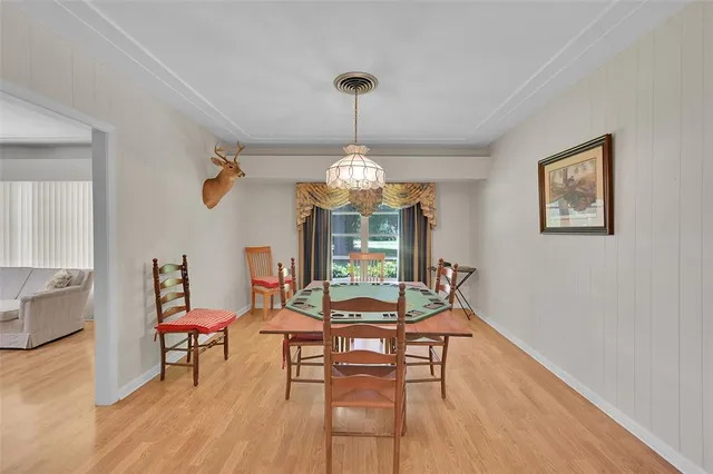 a kitchen with stainless steel appliances kitchen island granite countertop a table and chairs in it
