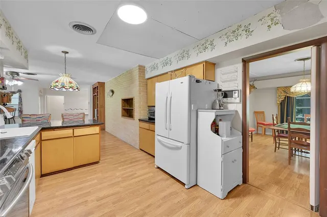a bathroom with a granite countertop sink toilet a mirror and shower
