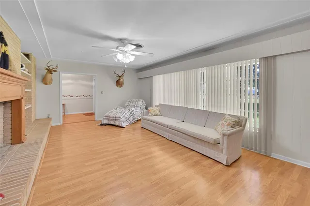 a living room with furniture kitchen view and a chandelier