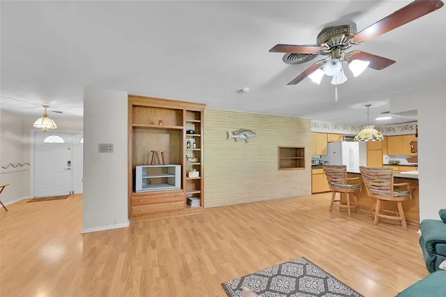 a bathroom with a sink a light fixture and a glass door