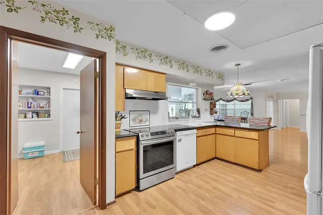 a bed room with a bed and a chandelier