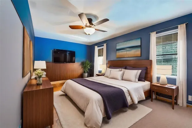 a view of a patio with couches and a table and chairs under an umbrella