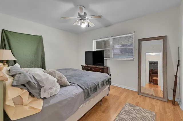 an aerial view of residential house with outdoor space and trees all around