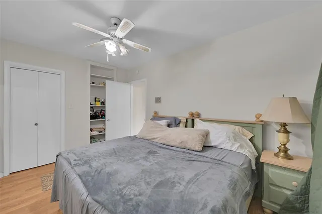 an aerial view of residential houses with outdoor space and trees