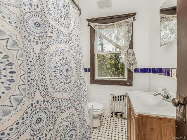 a view of a hallway with wooden floor and entryway