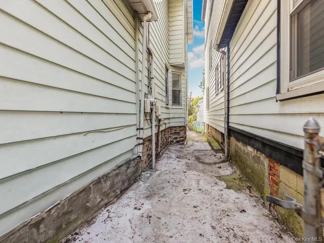 a backyard of a house with plants and outdoor seating