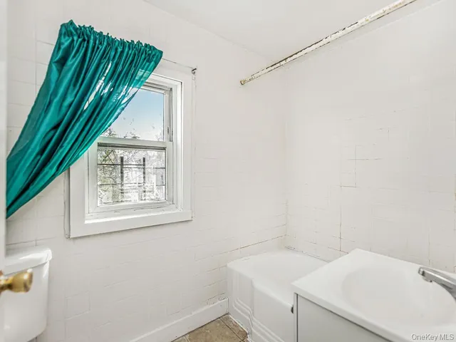a view of a room with wooden floor and bathroom