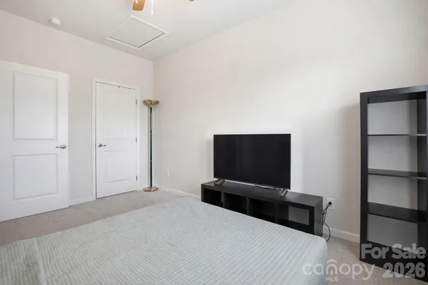 a bed room with a bed and a chair