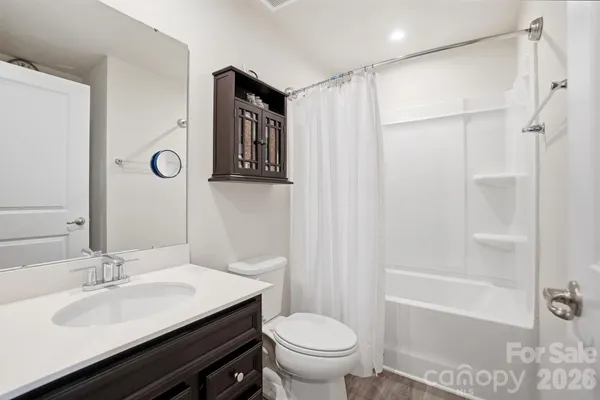 a view of a hallway with wooden floor and entryway