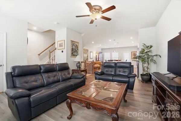 a kitchen with stainless steel appliances kitchen island granite countertop a table and chairs in it
