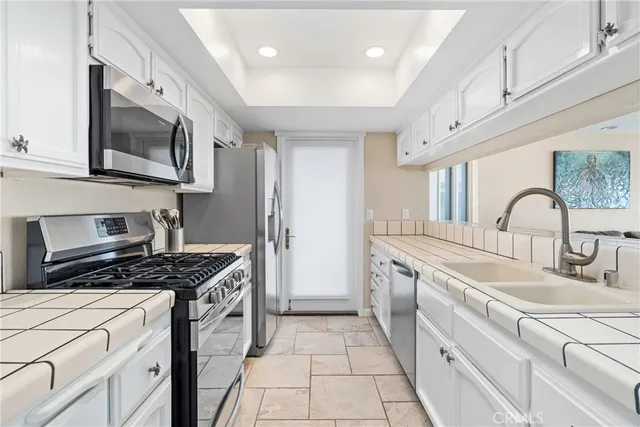 a kitchen with stainless steel appliances granite countertop a stove a refrigerator and cabinets