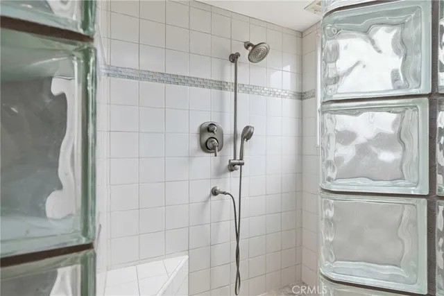 a bedroom with bed and a chandelier