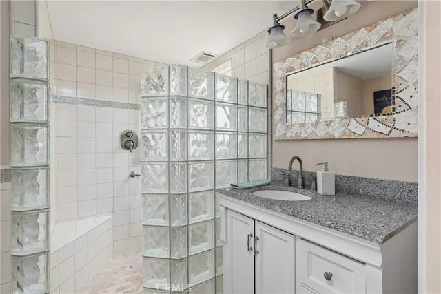 a bathroom with a glass shower door