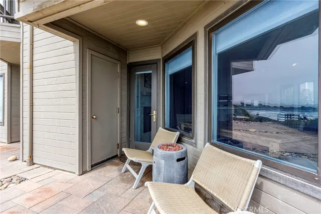 a view of a patio with a dining table and chairs