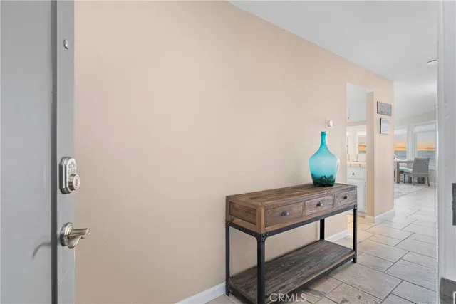 a living room with furniture large windows and view of bedroom