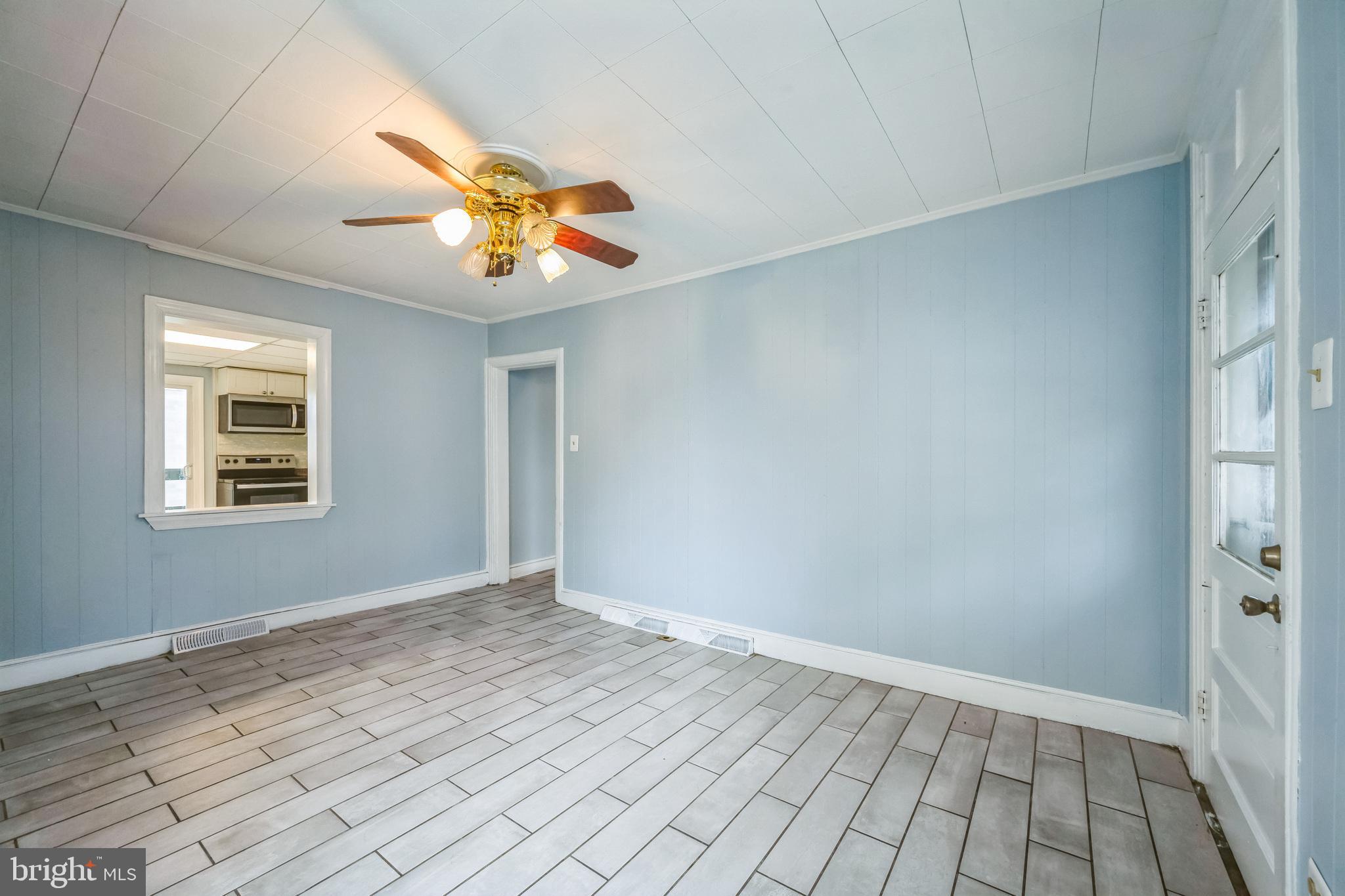 48 Elizabeth Street Hagerstown, MD 21740 - Photo 22 of 48 a view of an empty room with window and chandelier fan