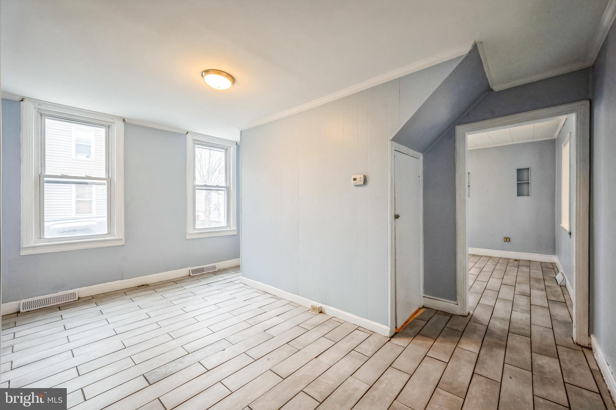 48 Elizabeth Street Hagerstown, MD 21740 - Photo 27 of 48 a view of an empty room with window and wooden floor