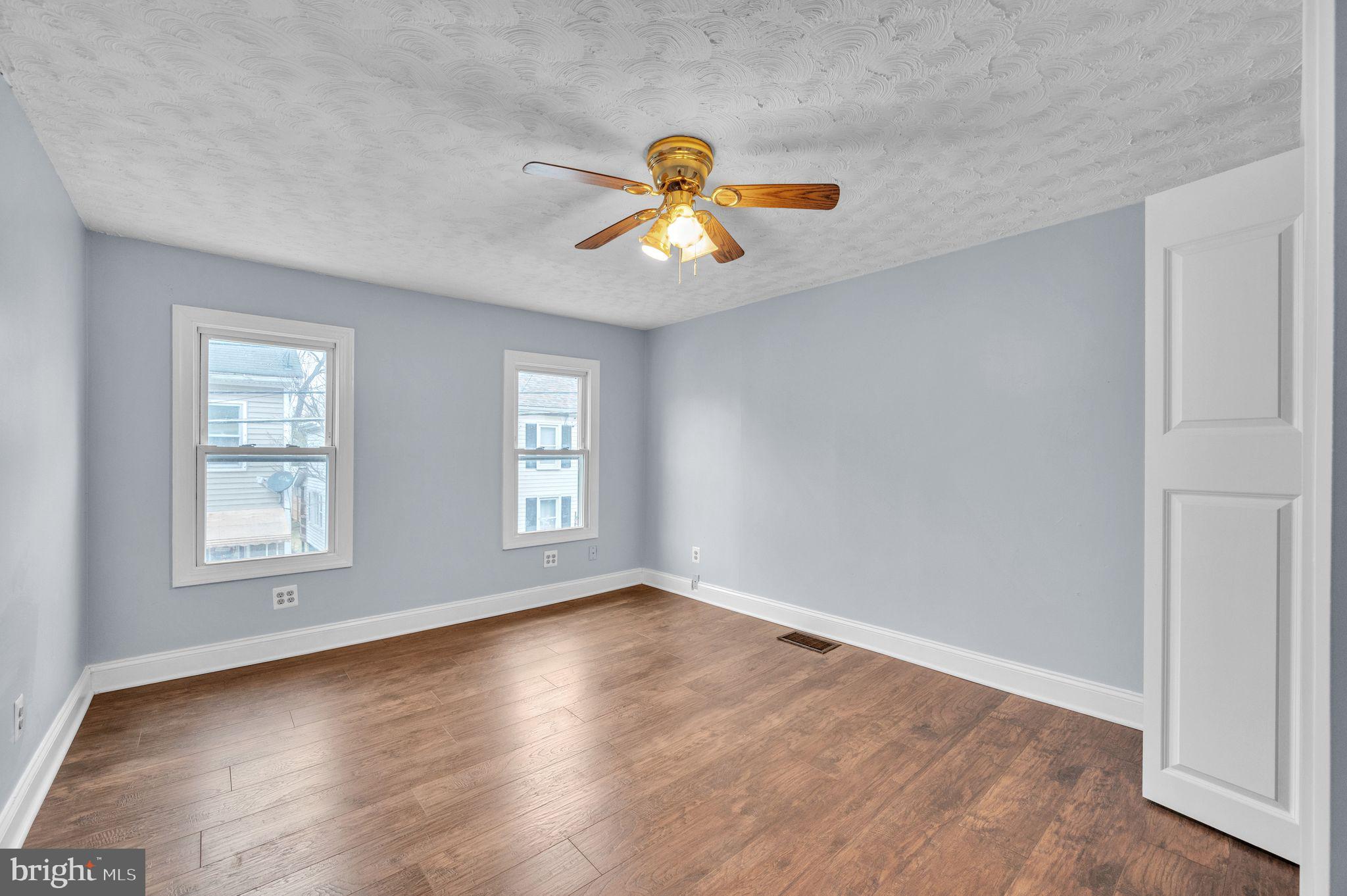 48 Elizabeth Street Hagerstown, MD 21740 - Photo 30 of 48 a view of empty room with wooden floor and fan