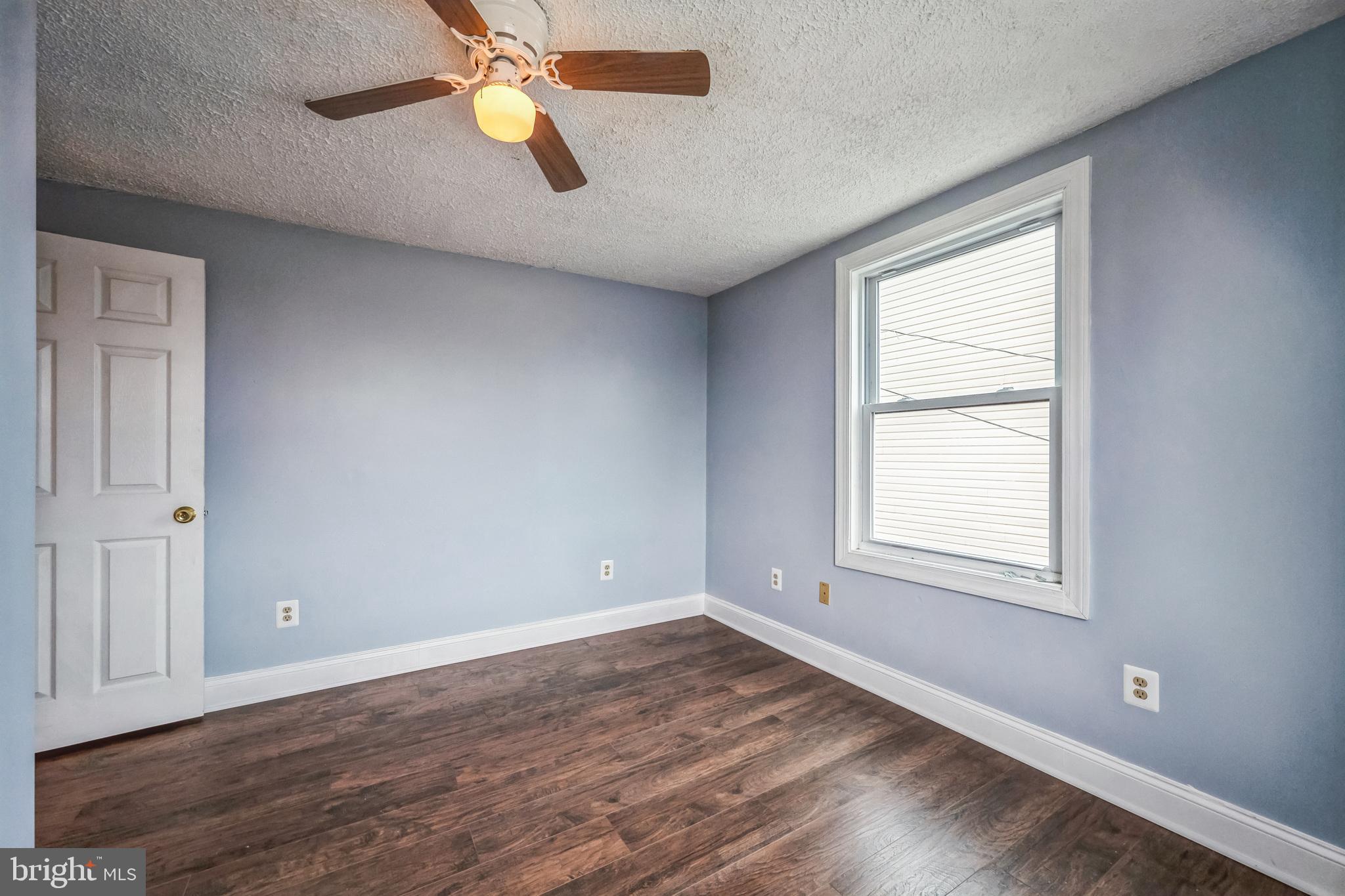 48 Elizabeth Street Hagerstown, MD 21740 - Photo 37 of 48 an empty room with wooden floor and windows
