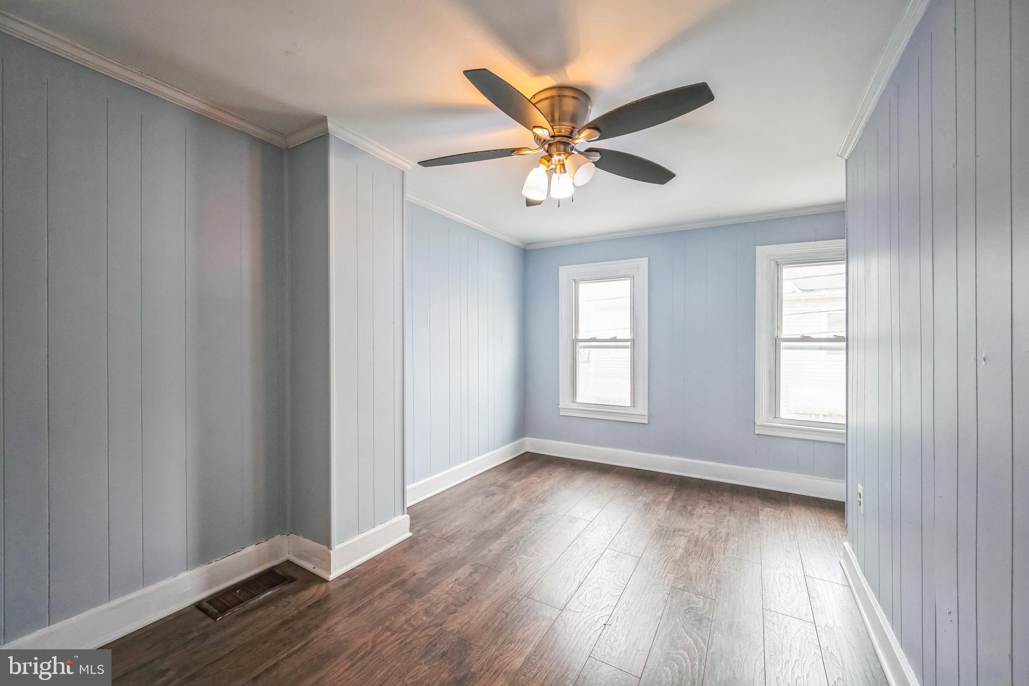 48 Elizabeth Street Hagerstown, MD 21740 - Photo 38 of 48 an empty room with wooden floor fan and windows