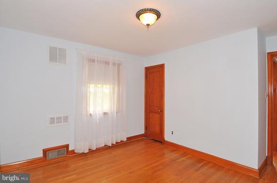 1253 Elm Road Baltimore, MD 21227 - Photo 8 of 29 a view of an empty room with a window