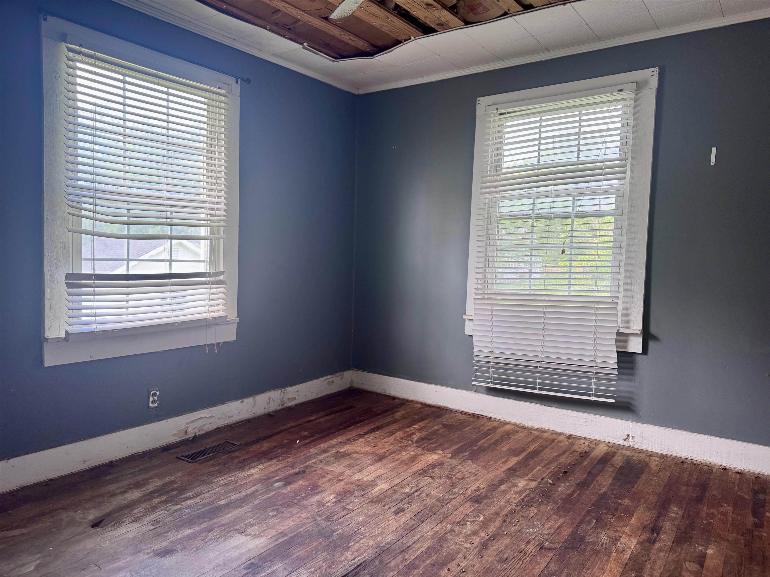 237 Old Shiloh Road Adamsville, TN 38310 - Photo 5 of 11 a view of an empty room with wooden floor and a window