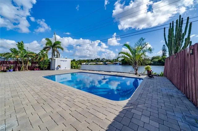 a view of a swimming pool and lounge chairs
