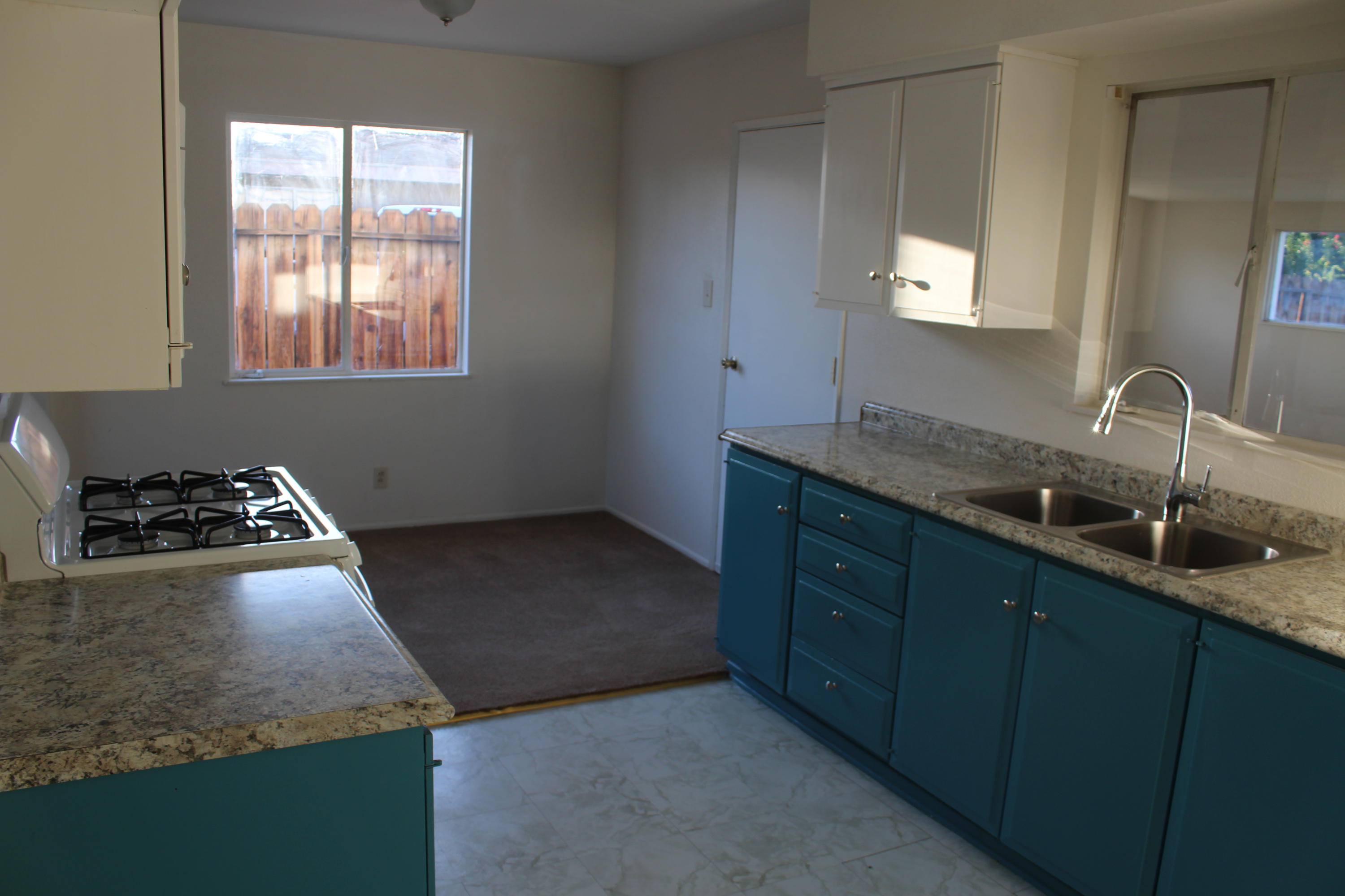 82396 Adobe Road Indio, CA 92201 - Photo 11 of 53 a kitchen with a sink stove and cabinets