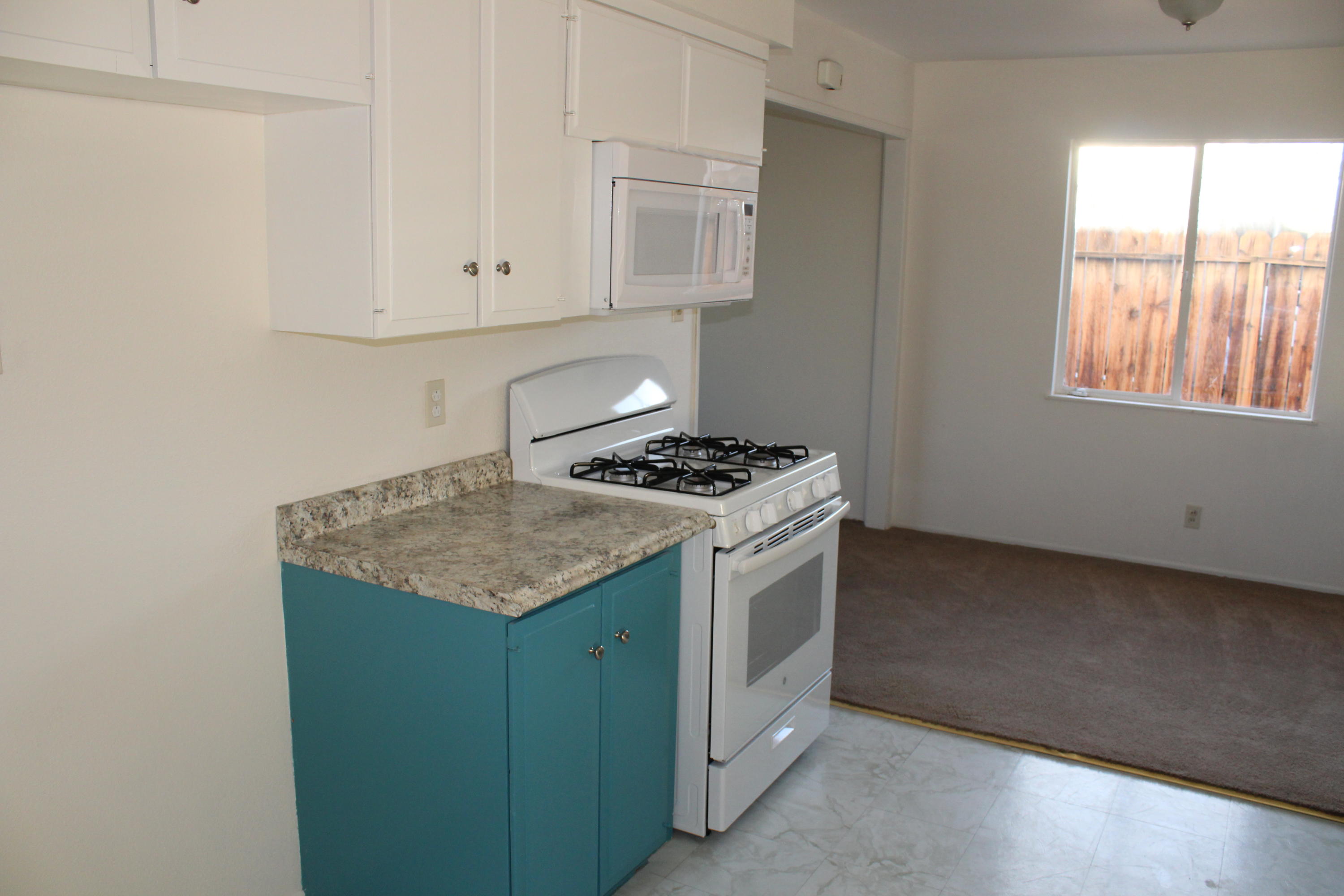82396 Adobe Road Indio, CA 92201 - Photo 13 of 53 a kitchen with granite countertop cabinets appliances and a window