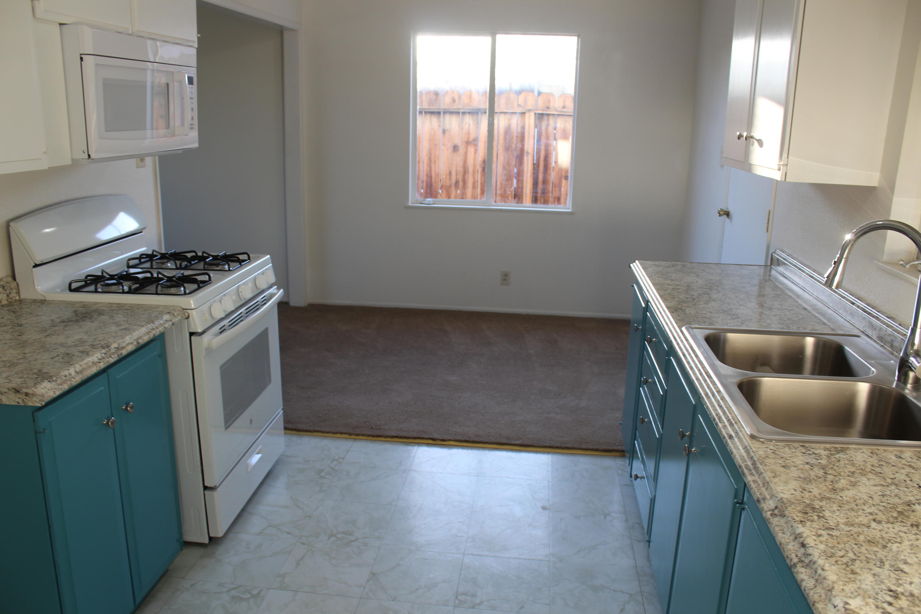 82396 Adobe Road Indio, CA 92201 - Photo 15 of 53 a kitchen with granite countertop a sink a stove and cabinets