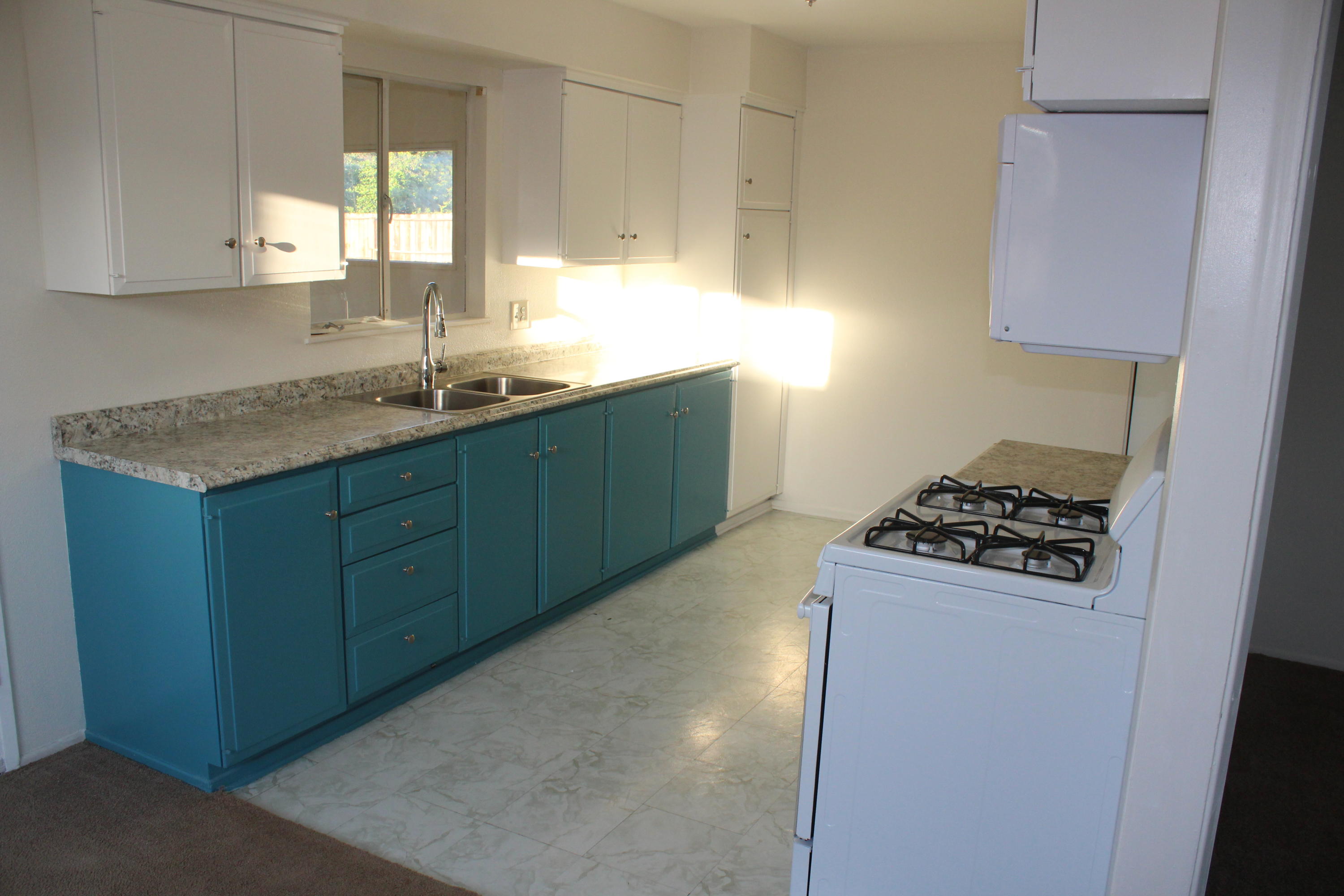 82396 Adobe Road Indio, CA 92201 - Photo 16 of 53 a kitchen with granite countertop a sink stove and cabinets