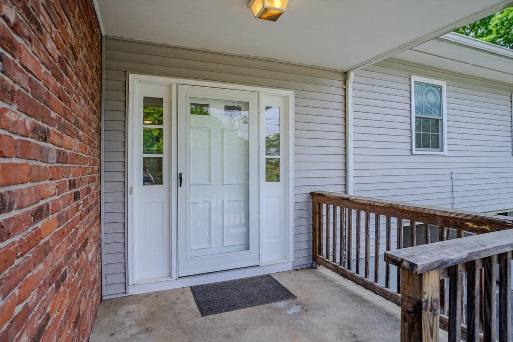 463 Bay Road Amherst, MA 01002 - Photo 6 of 9 a view of a porch with a door and wooden floor
