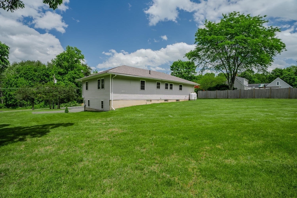463 Bay Road Amherst, MA 01002 - Photo 8 of 9 a white house with a big yard plants and large trees