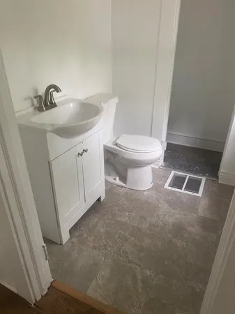 a bathroom with a sink a toilet and a mirror