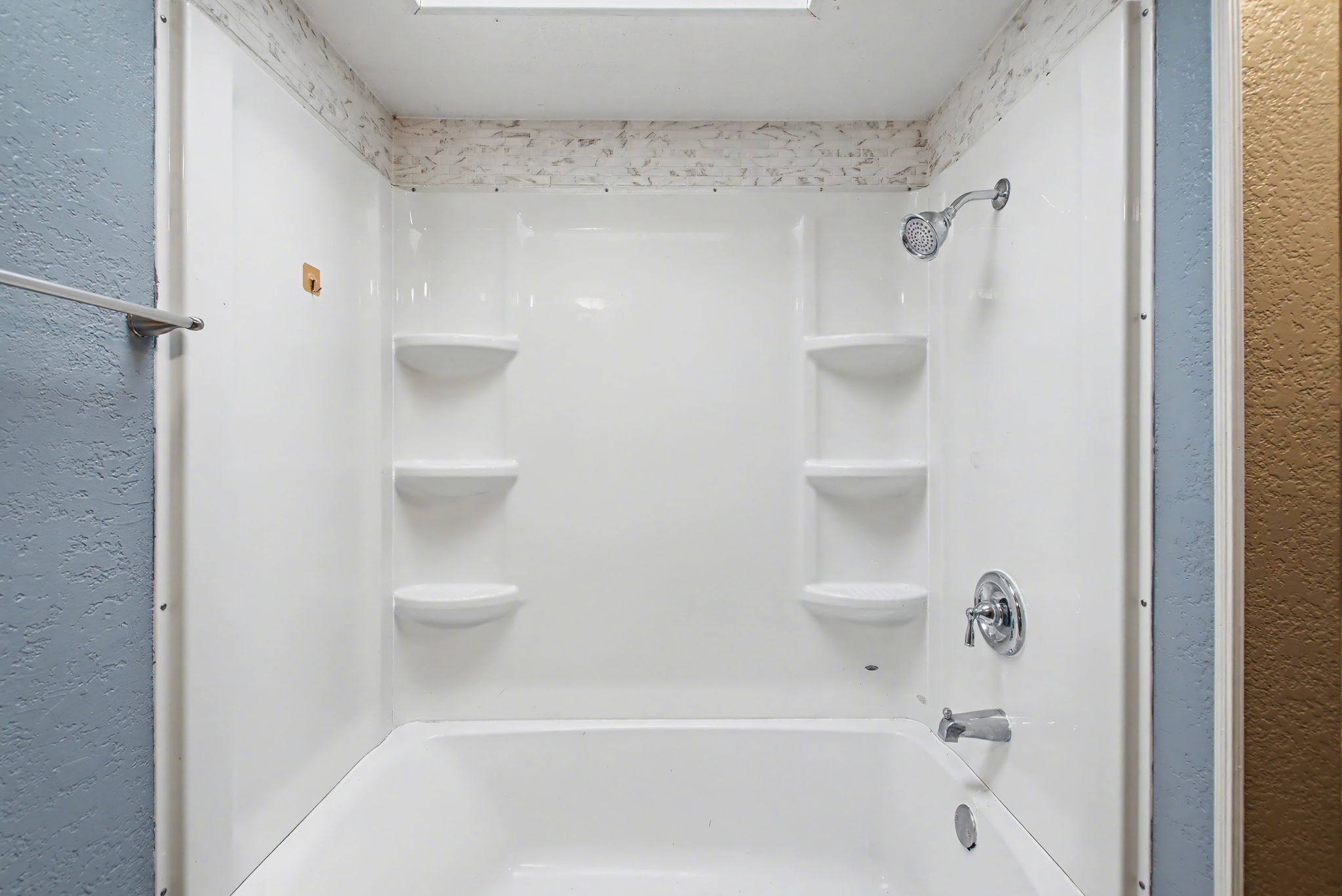 919 Austin Street Kingsland, TX 78639 - Photo 15 of 20 a bathroom with a bathtub and a shower