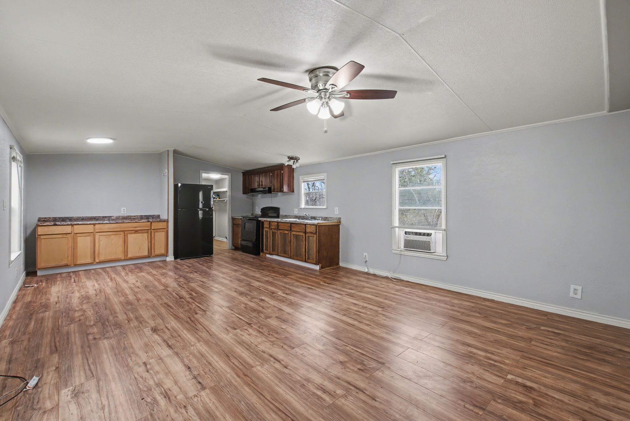919 Austin Street Kingsland, TX 78639 - Photo 5 of 20 a view of empty room with wooden floor and window
